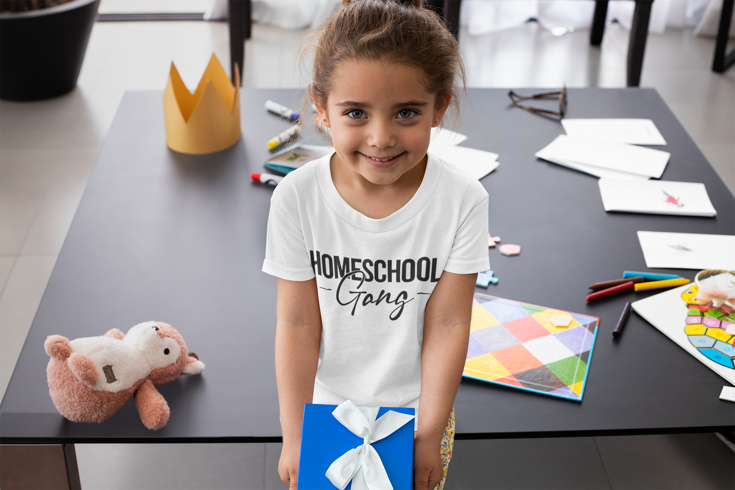 Child proudly wearing the Kids Homeschool Gang Tee, displaying its vibrant design and comfortable fit.